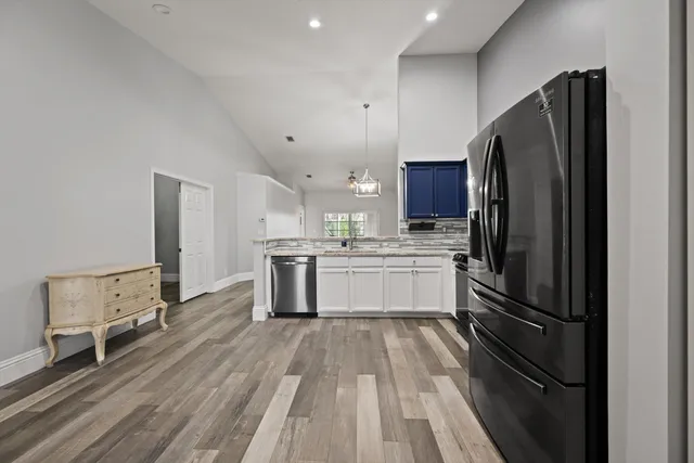 a kitchen with stainless steel appliances a refrigerator sink and cabinets