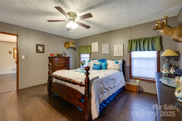 a bedroom with a bed and flat screen tv