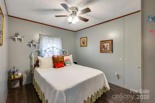 a bedroom with a bed dresser and a window