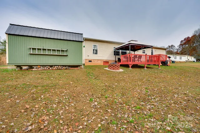 a view of a chairs and table in the backyard
