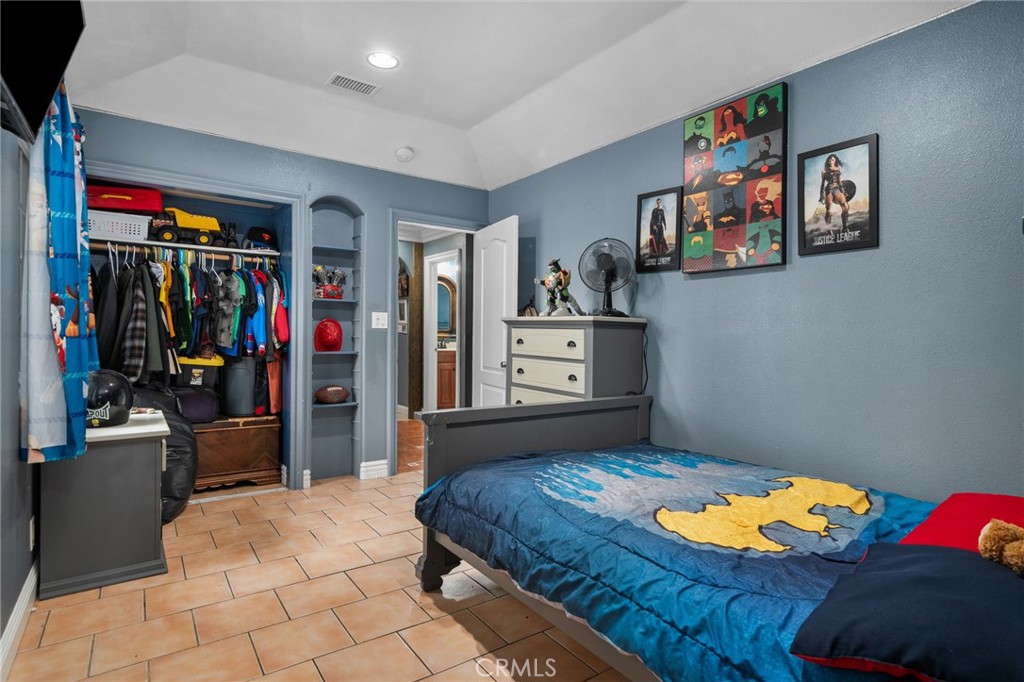 8538 Trey Avenue Riverside, CA 92503 - Photo 13 of 25 a bedroom with a bed and a cabinets