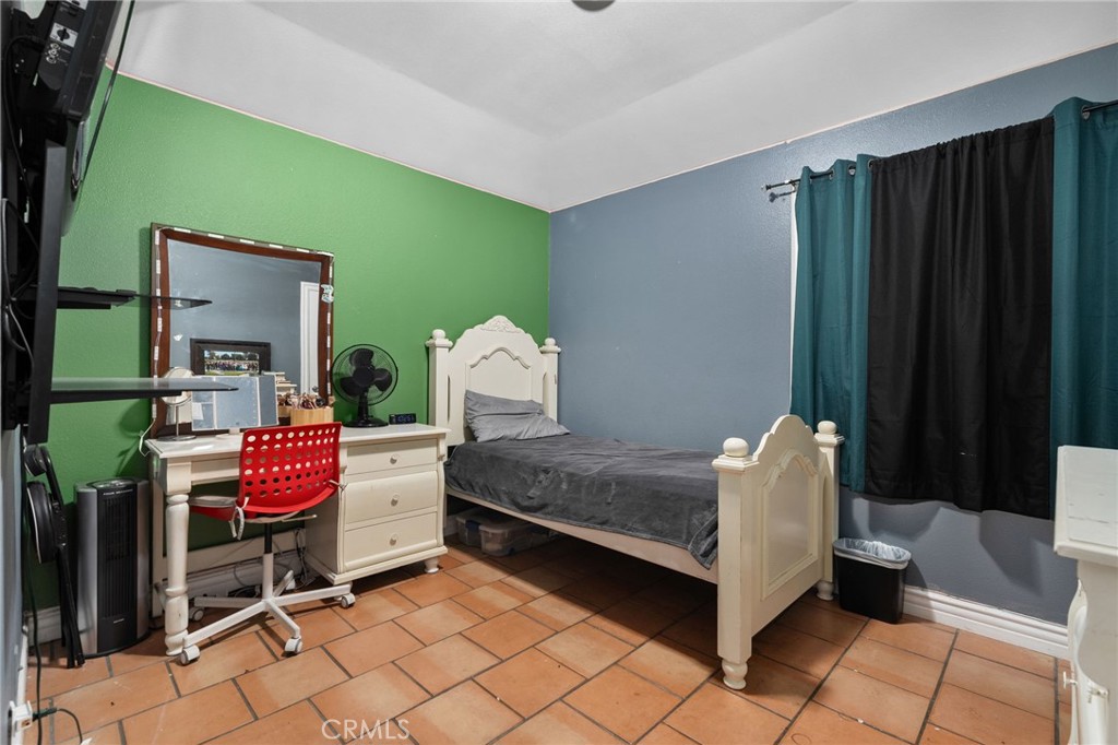 8538 Trey Avenue Riverside, CA 92503 - Photo 16 of 25 a bedroom with a bed and a cabinets