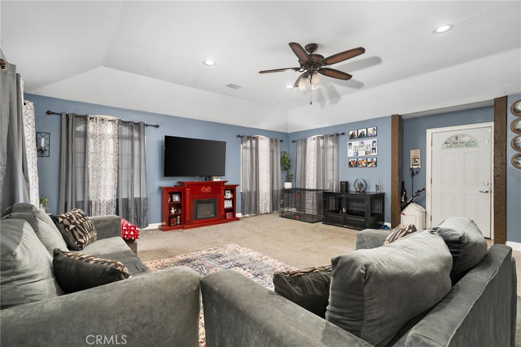8538 Trey Avenue Riverside, CA 92503 - Photo 4 of 25 a living room with furniture and a flat screen tv