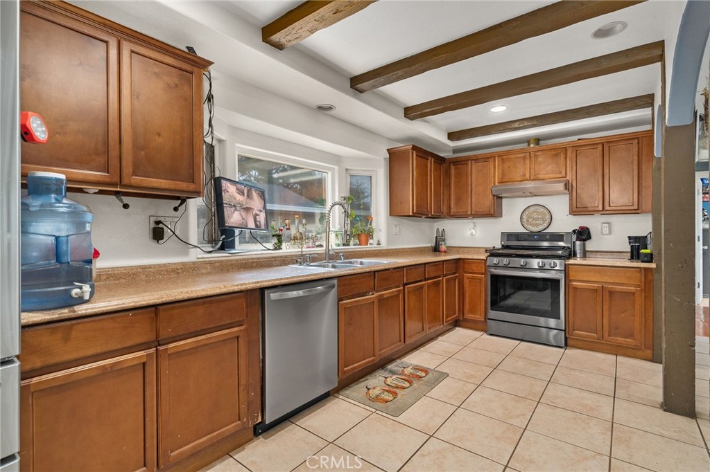 8538 Trey Avenue Riverside, CA 92503 - Photo 6 of 25 a kitchen with granite countertop a sink stainless steel appliances and cabinets