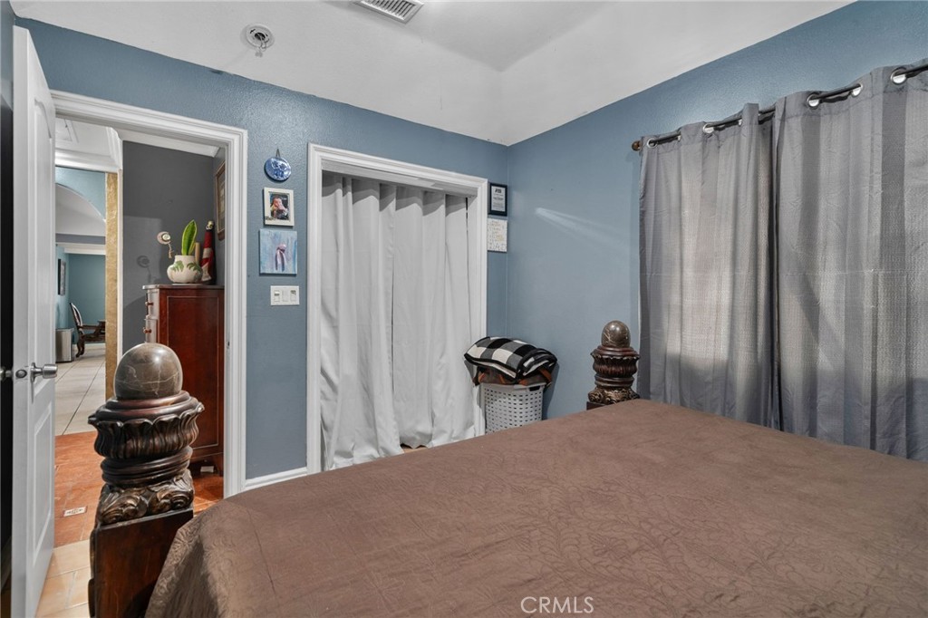 8538 Trey Avenue Riverside, CA 92503 - Photo 10 of 25 a bedroom with a bed and a closet