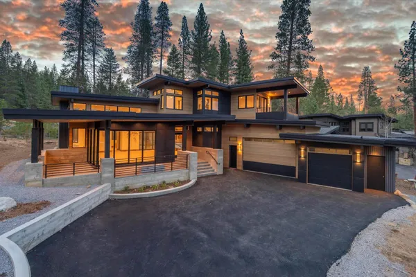 a view of a house with backyard and sitting area