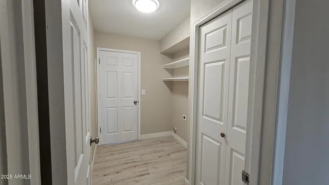 a view of a hallway with wooden floor
