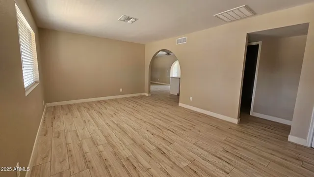 wooden floor in an empty room with a window