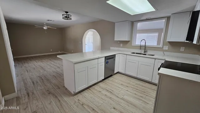 a kitchen with a sink cabinets and wooden floor
