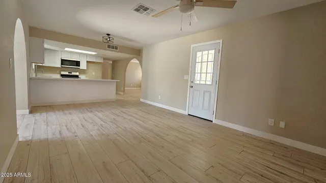 a view of a kitchen with wooden floor and a sink