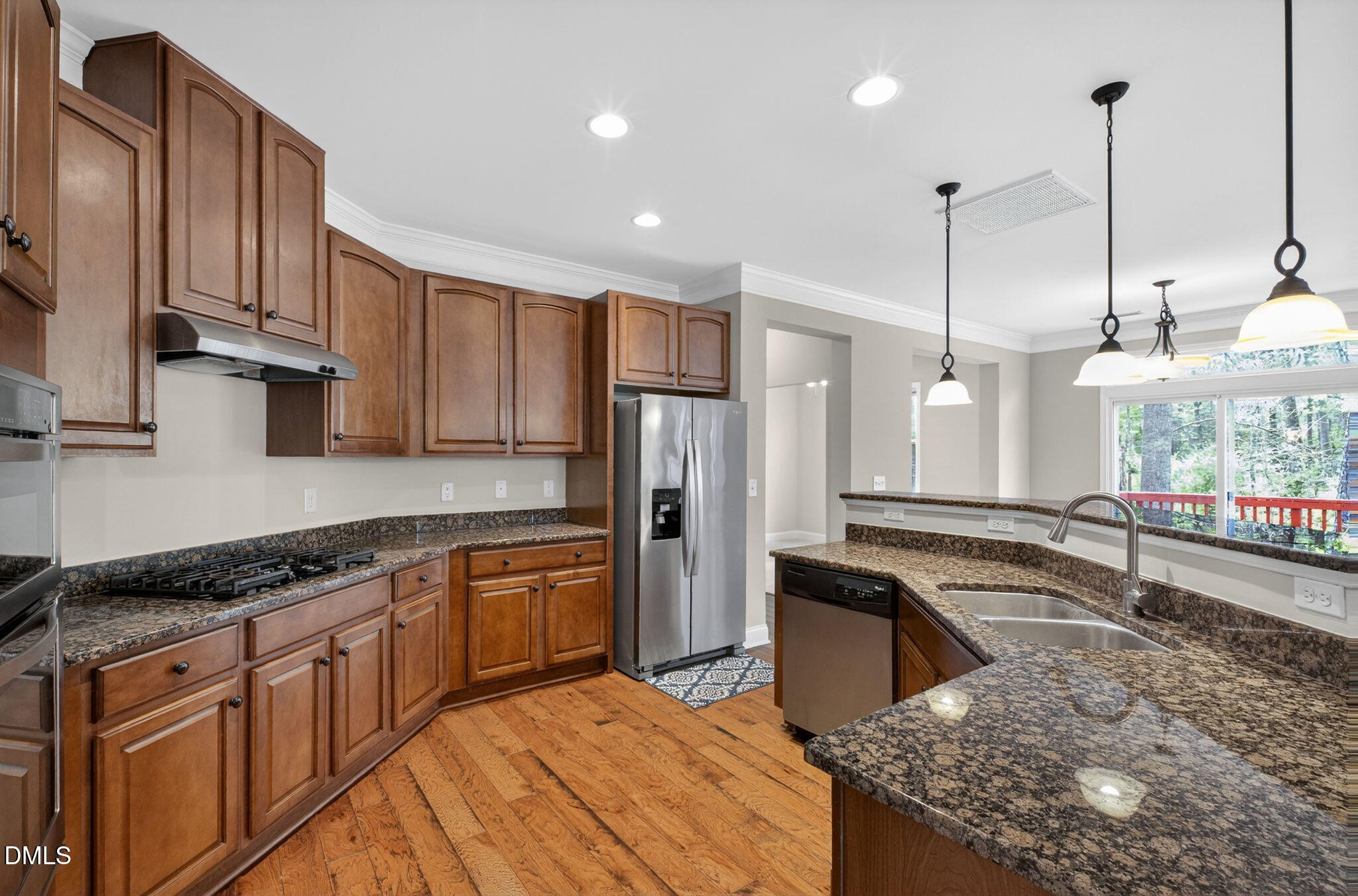 1304 Barnford Mill Road Wake Forest, NC 27587 - Photo 13 of 44 a kitchen with stainless steel appliances granite countertop a sink a stove and a wooden cabinets