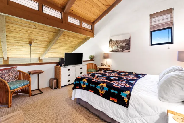 a bedroom with bed and a window