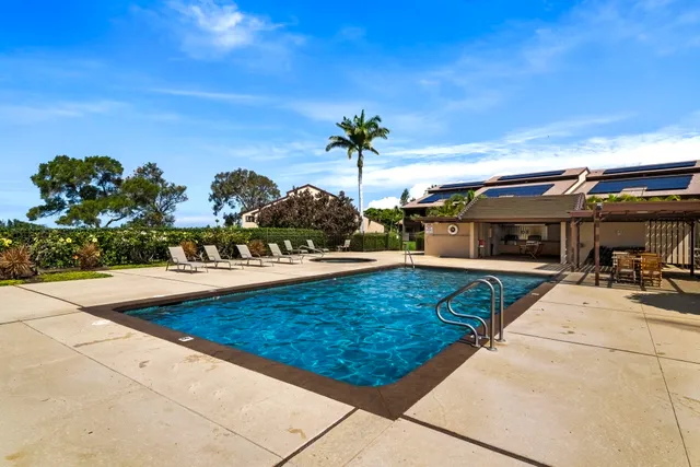 a view of swimming pool with outdoor seating and a potted plant