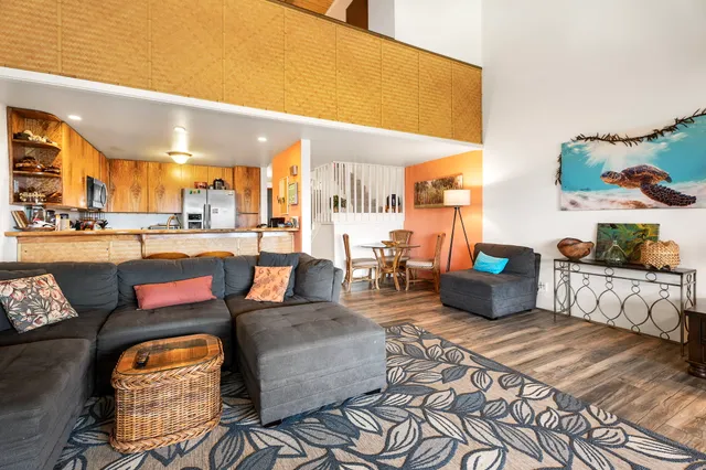 a living room with furniture and a floor to ceiling window