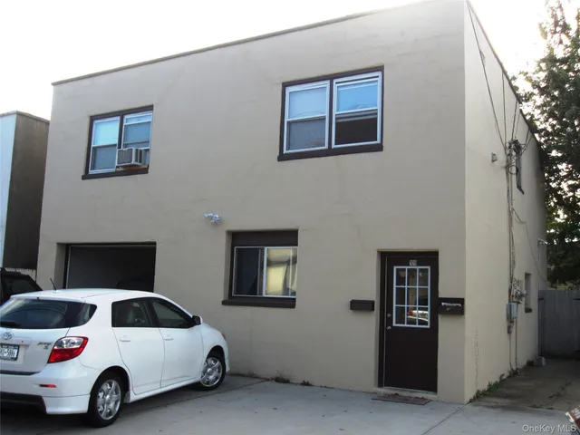 a view of a car parked in front of a house