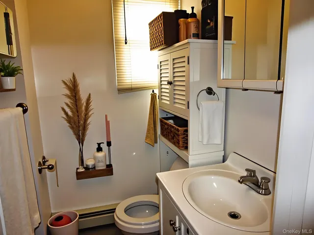 a bathroom with a sink a toilet and shower curtain