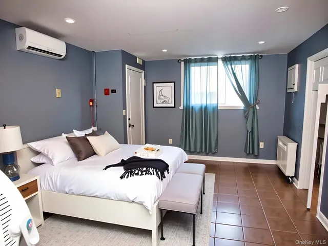 a bedroom with a bed and a large mirror