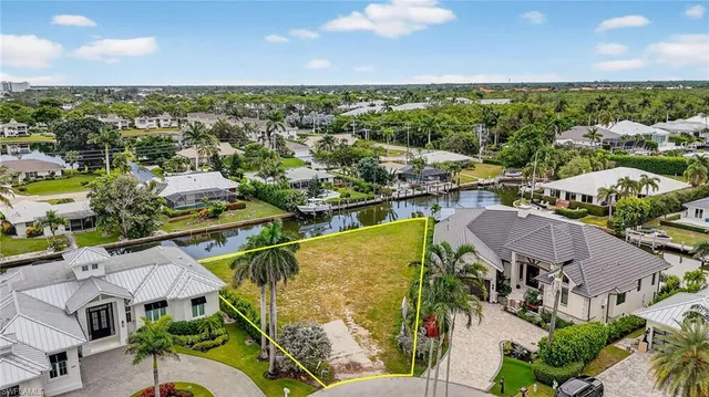 an aerial view of residential houses with outdoor space and ocean view