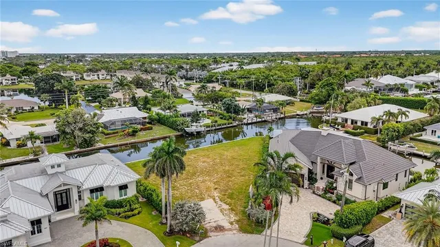 an aerial view of residential houses with outdoor space and ocean view
