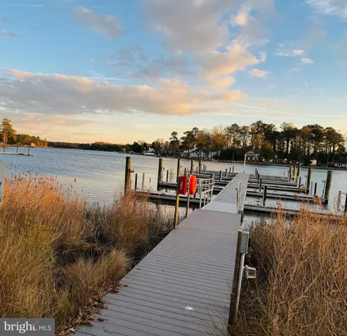 a living room with wooden floor and flat screen tv