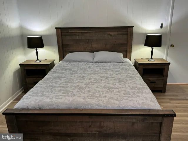 a bedroom with a bed and a lamp