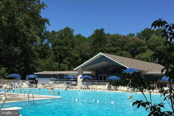 a front view of a house with a yard table and chairs