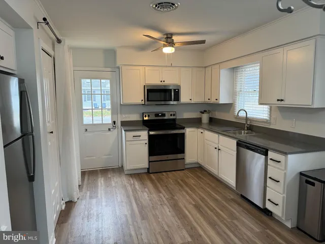 a kitchen with a stove a sink and a refrigerator