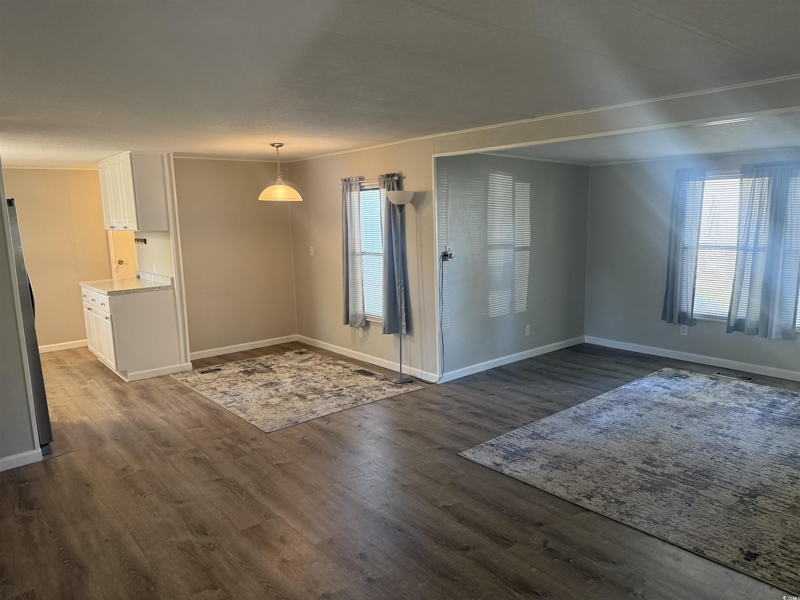 826 Jensen Drive North Murrells Inlet, SC 29576 - Photo 11 of 38 Unfurnished dining area featuring dark wood-style floors and healthy amount of natural light