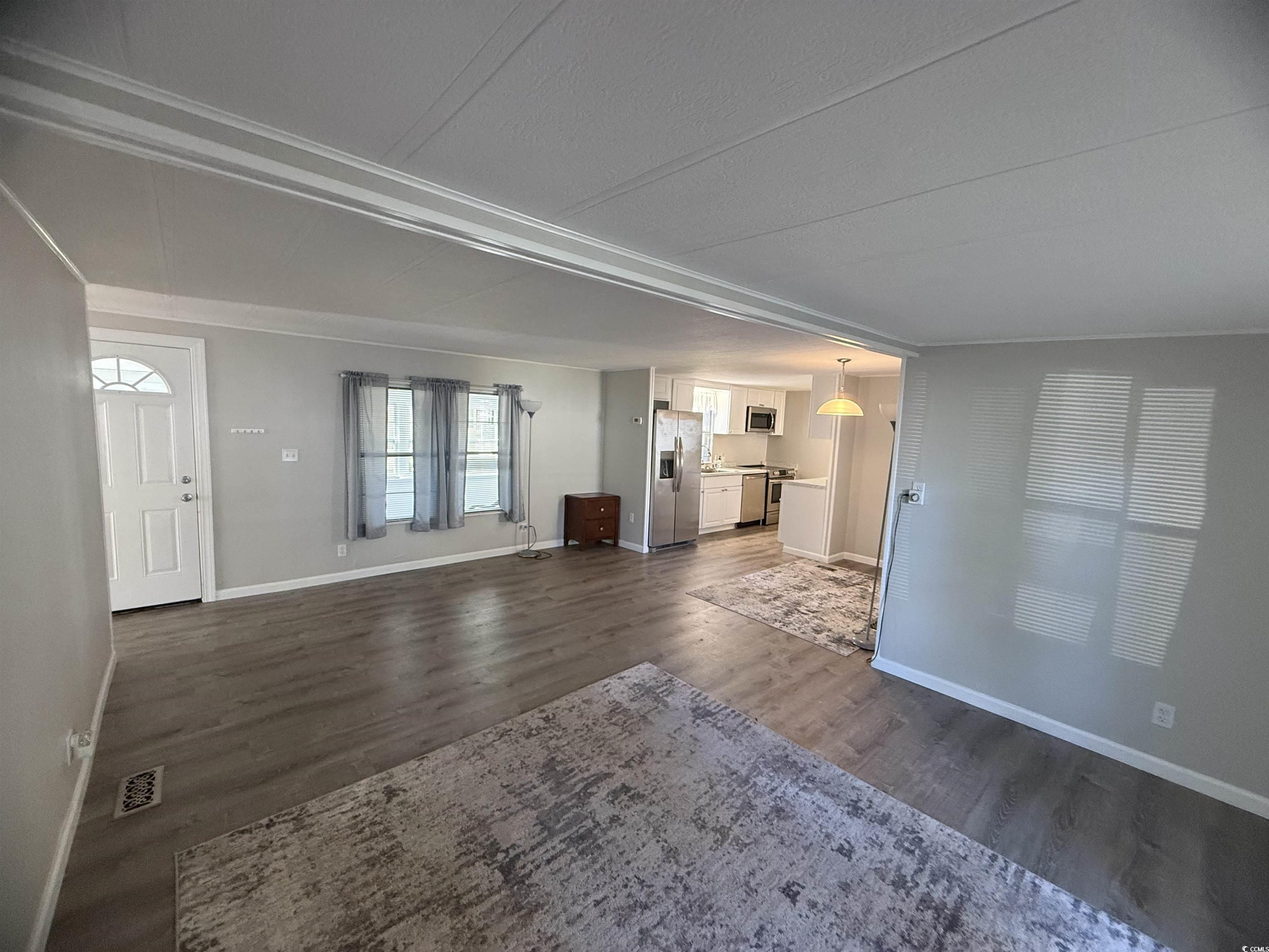 826 Jensen Drive North Murrells Inlet, SC 29576 - Photo 15 of 38 Unfurnished living room featuring dark wood finished floors