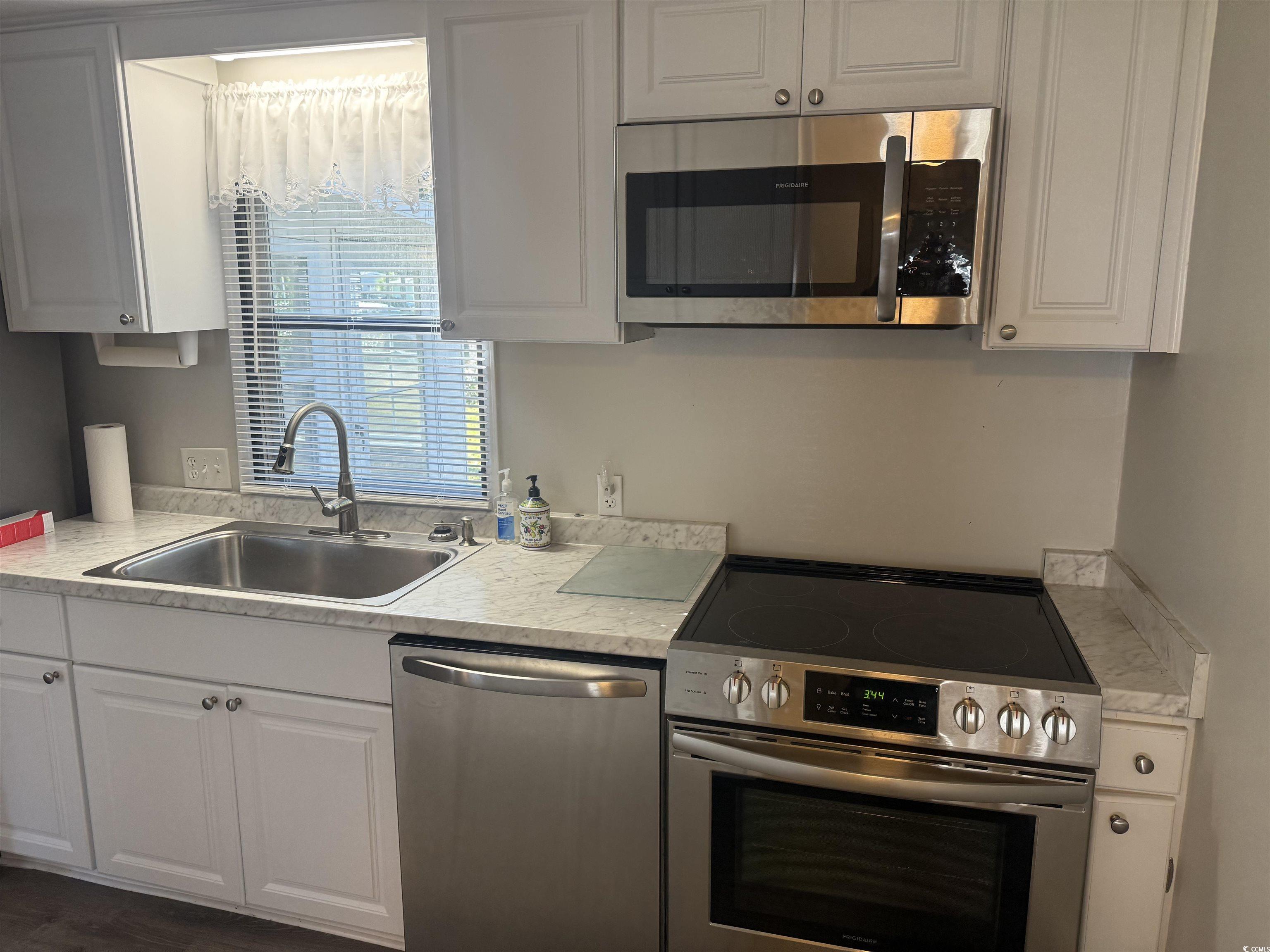 826 Jensen Drive North Murrells Inlet, SC 29576 - Photo 20 of 38 Kitchen featuring appliances with stainless steel finishes, light countertops, and white cabinets