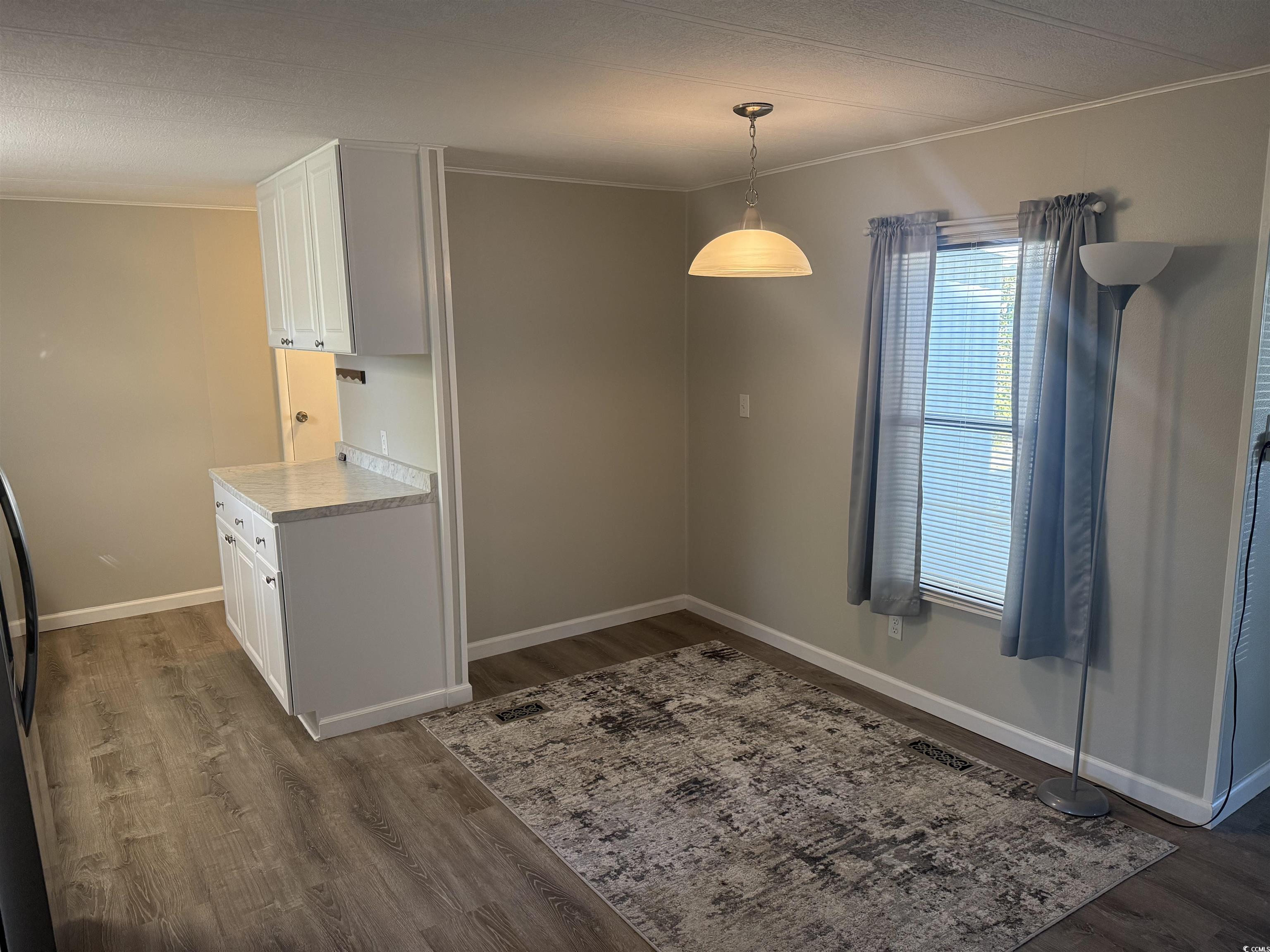 826 Jensen Drive North Murrells Inlet, SC 29576 - Photo 22 of 38 Unfurnished dining area featuring crown molding and dark wood-style flooring