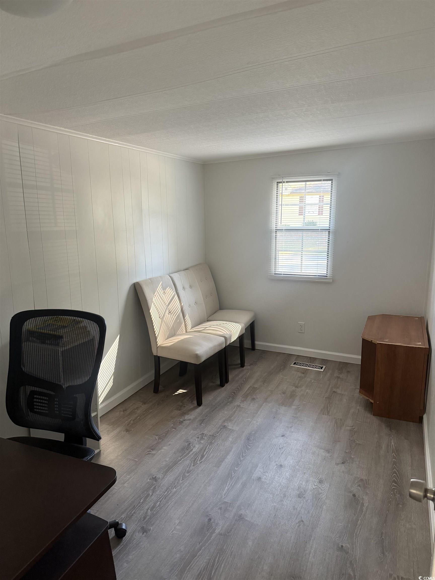 826 Jensen Drive North Murrells Inlet, SC 29576 - Photo 23 of 38 Sitting room featuring wood finished floors and wooden walls