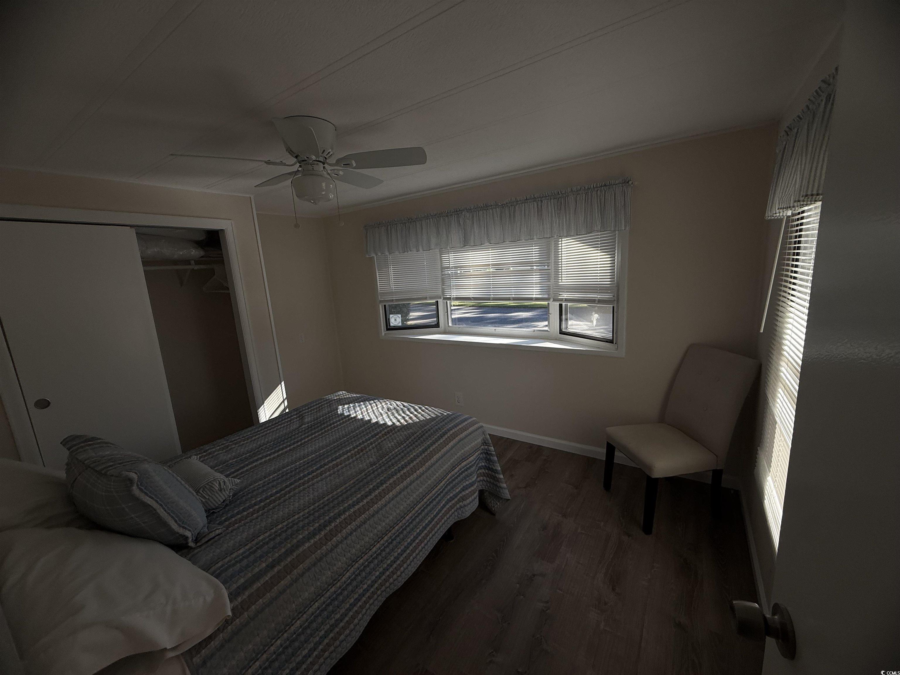826 Jensen Drive North Murrells Inlet, SC 29576 - Photo 36 of 38 Bedroom with dark wood-type flooring, ceiling fan, and a closet