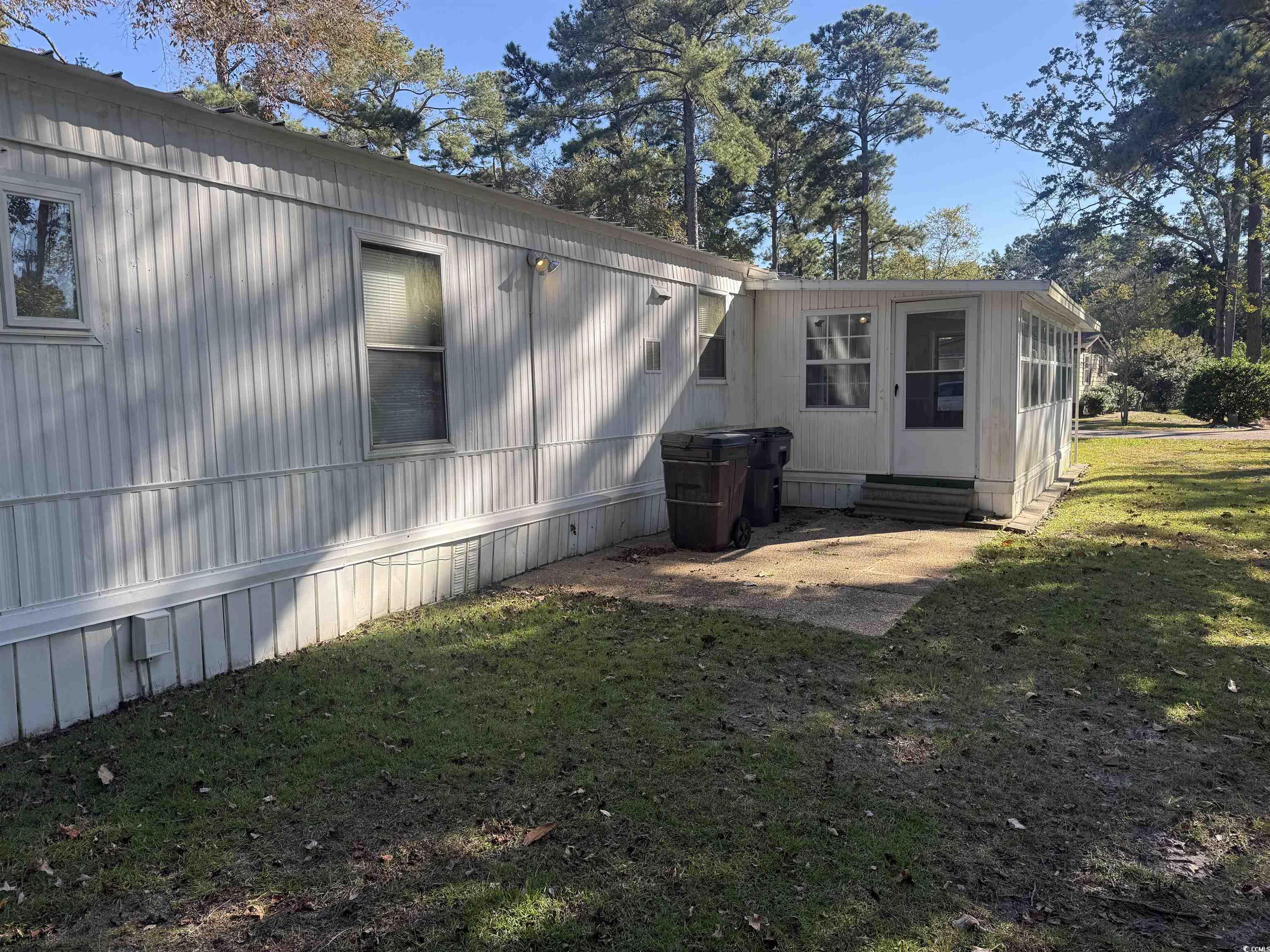826 Jensen Drive North Murrells Inlet, SC 29576 - Photo 5 of 38 Rear view of house featuring a lawn and entry steps