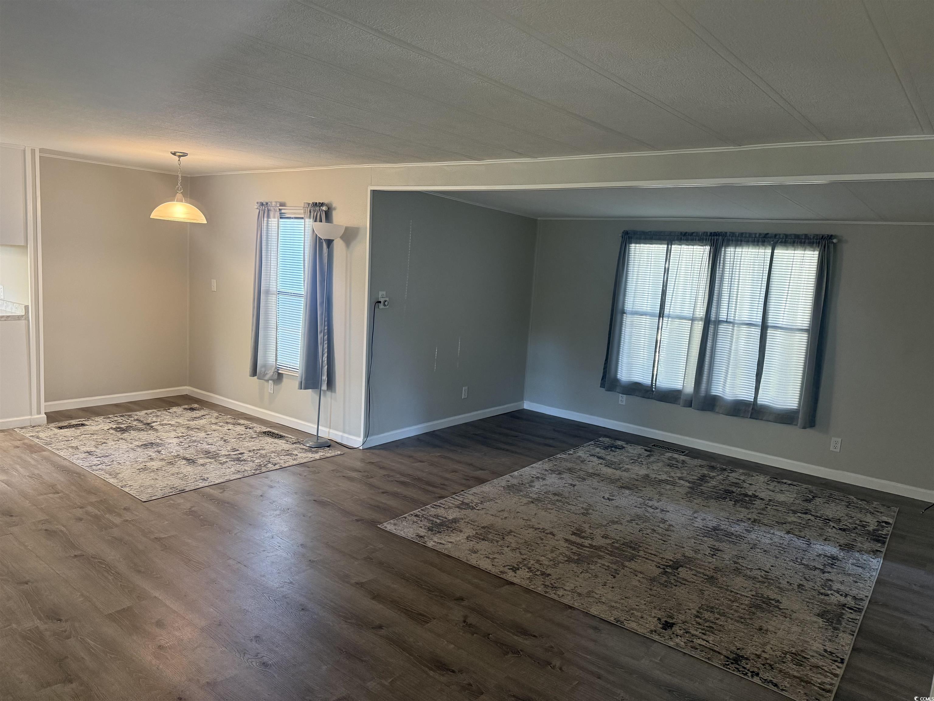 826 Jensen Drive North Murrells Inlet, SC 29576 - Photo 10 of 38 Spare room with plenty of natural light and dark wood-type flooring