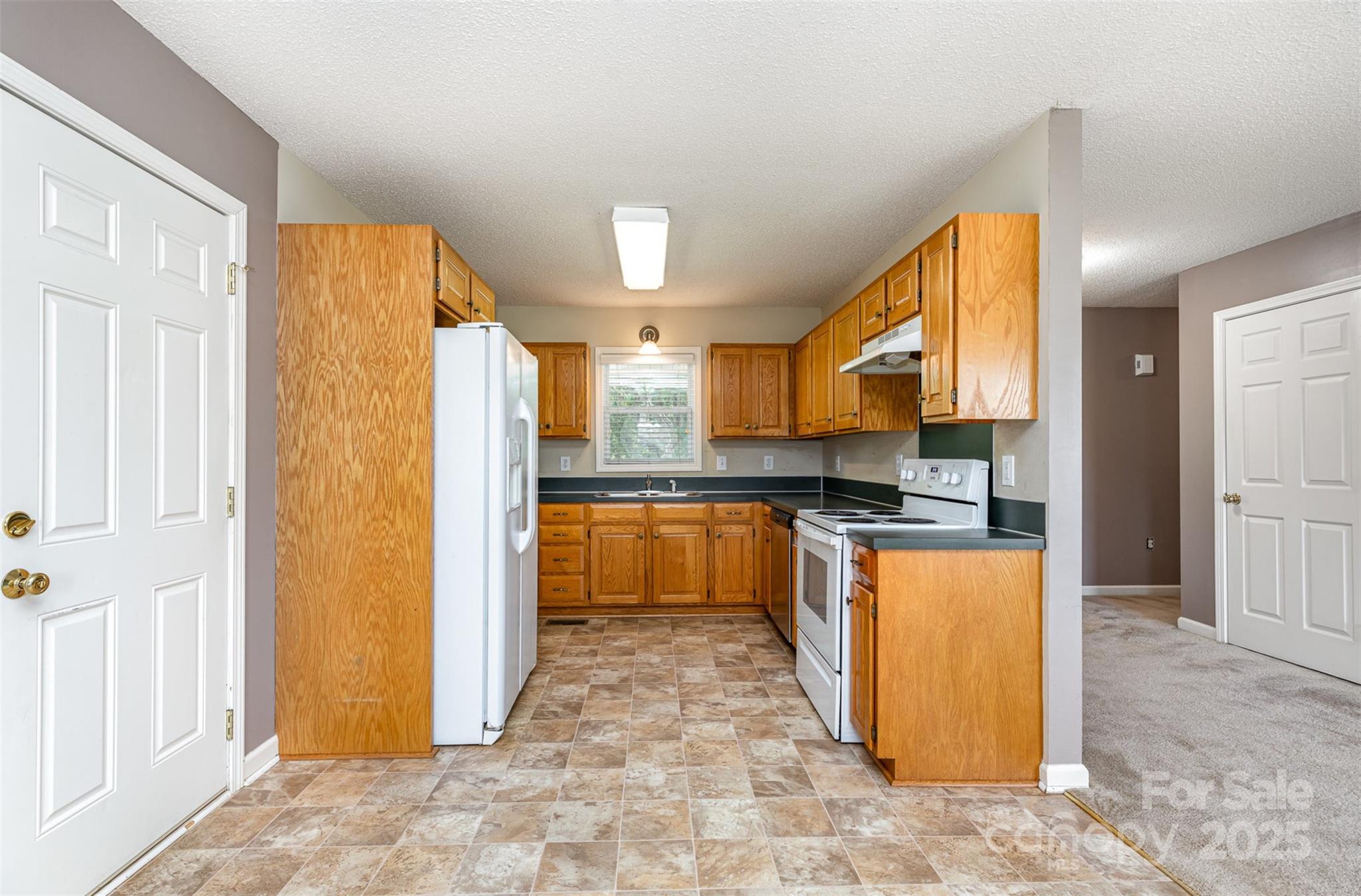 4751 Kemp Dellinger Road Maiden, NC 28650 - Photo 7 of 17 a kitchen with stainless steel appliances granite countertop a refrigerator and a stove top oven