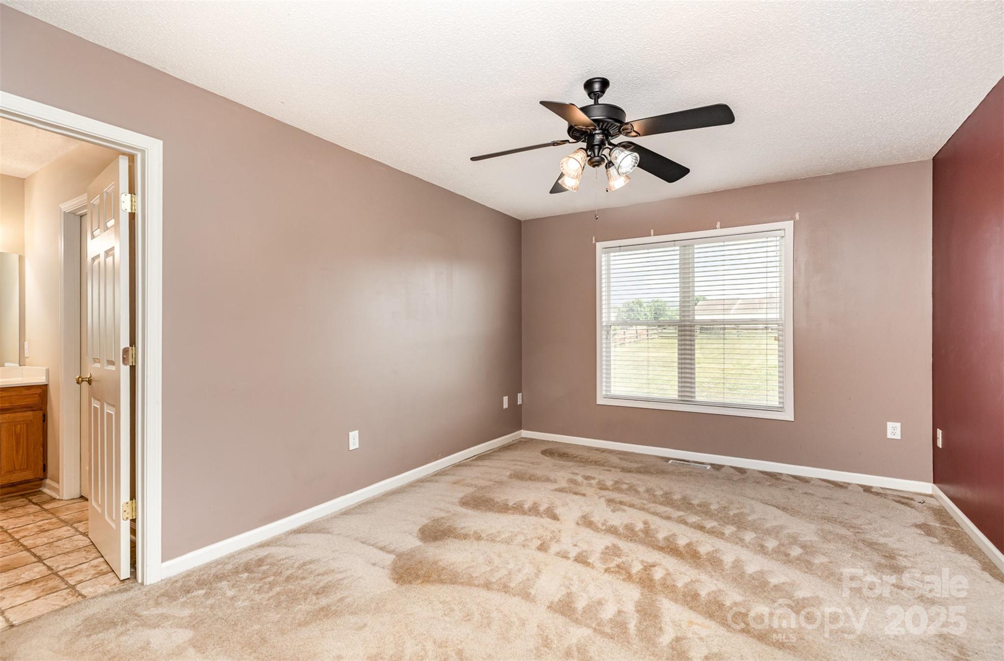 4751 Kemp Dellinger Road Maiden, NC 28650 - Photo 10 of 17 a view of a livingroom with a window and a ceiling fan