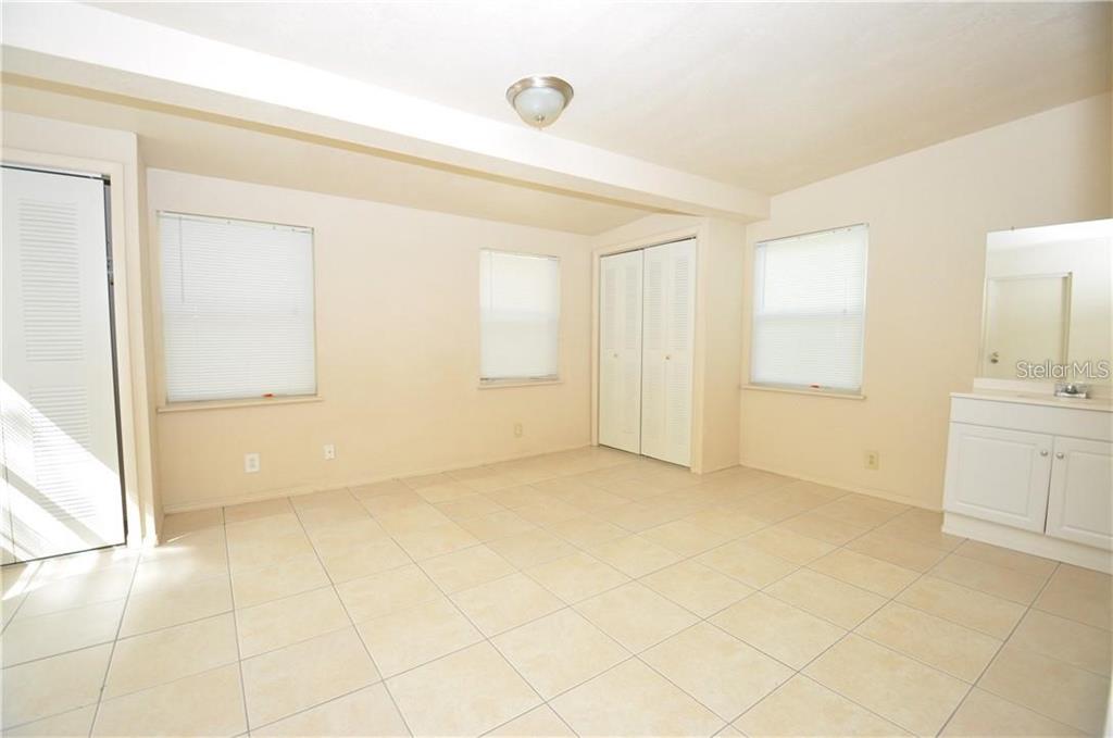 509 Norfolk Circle Lakeland, FL 33801 - Photo 12 of 14 a view of an empty room with cabinet and a window