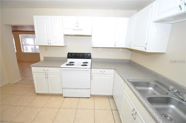 a kitchen with cabinets and white appliances
