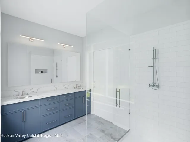 a spacious bathroom with a granite countertop sink mirror and double