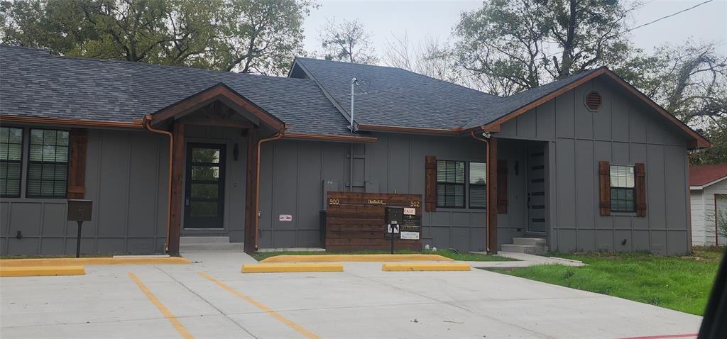 a view of a house with a patio and a yard
