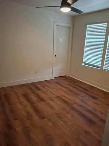 a view of a small house with backyard