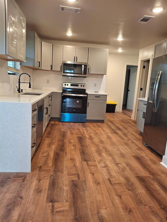 900 Chestnut Street Commerce, TX 75428 - Photo 5 of 19 a large kitchen with stainless steel appliances lots of counter top space