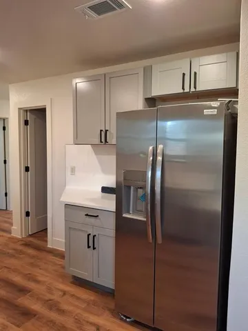 a kitchen with kitchen island a counter top space cabinets and stainless steel appliances