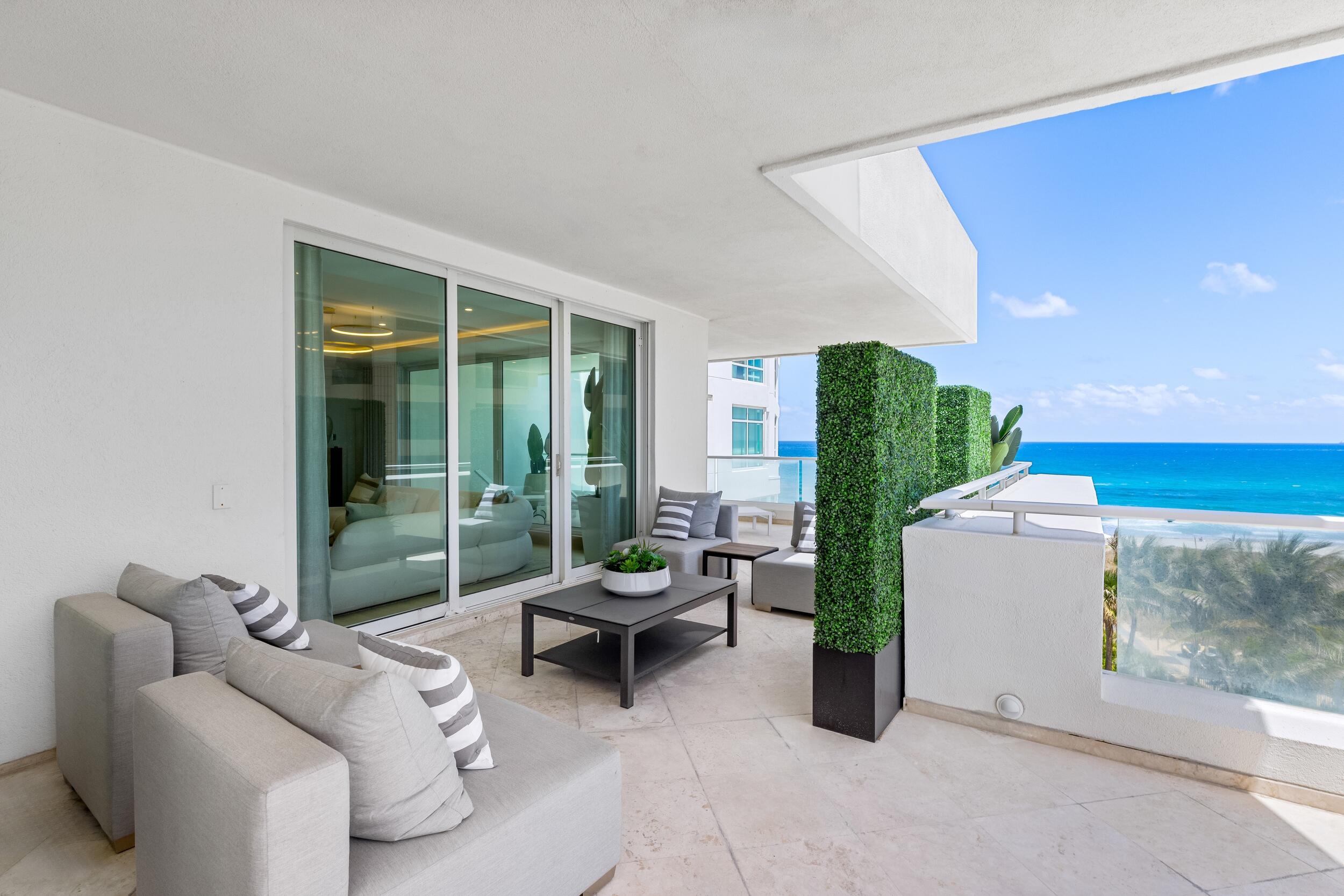 2494 South Ocean Boulevard, Unit C5 Boca Raton, FL 33432 - Photo 32 of 52 a living room with furniture and a floor to ceiling window