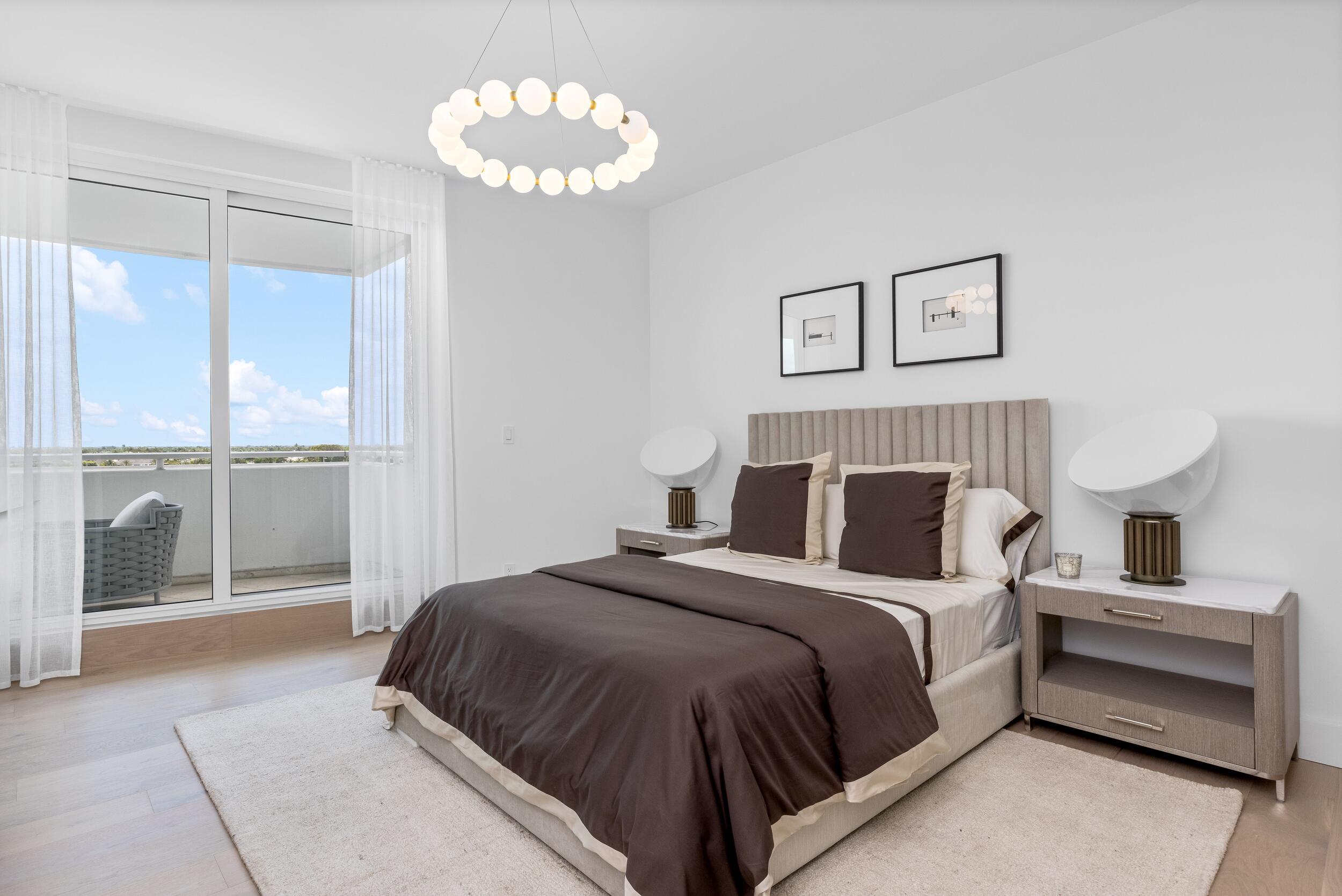 2494 South Ocean Boulevard, Unit C5 Boca Raton, FL 33432 - Photo 42 of 52 a bedroom with a large bed and a chandelier