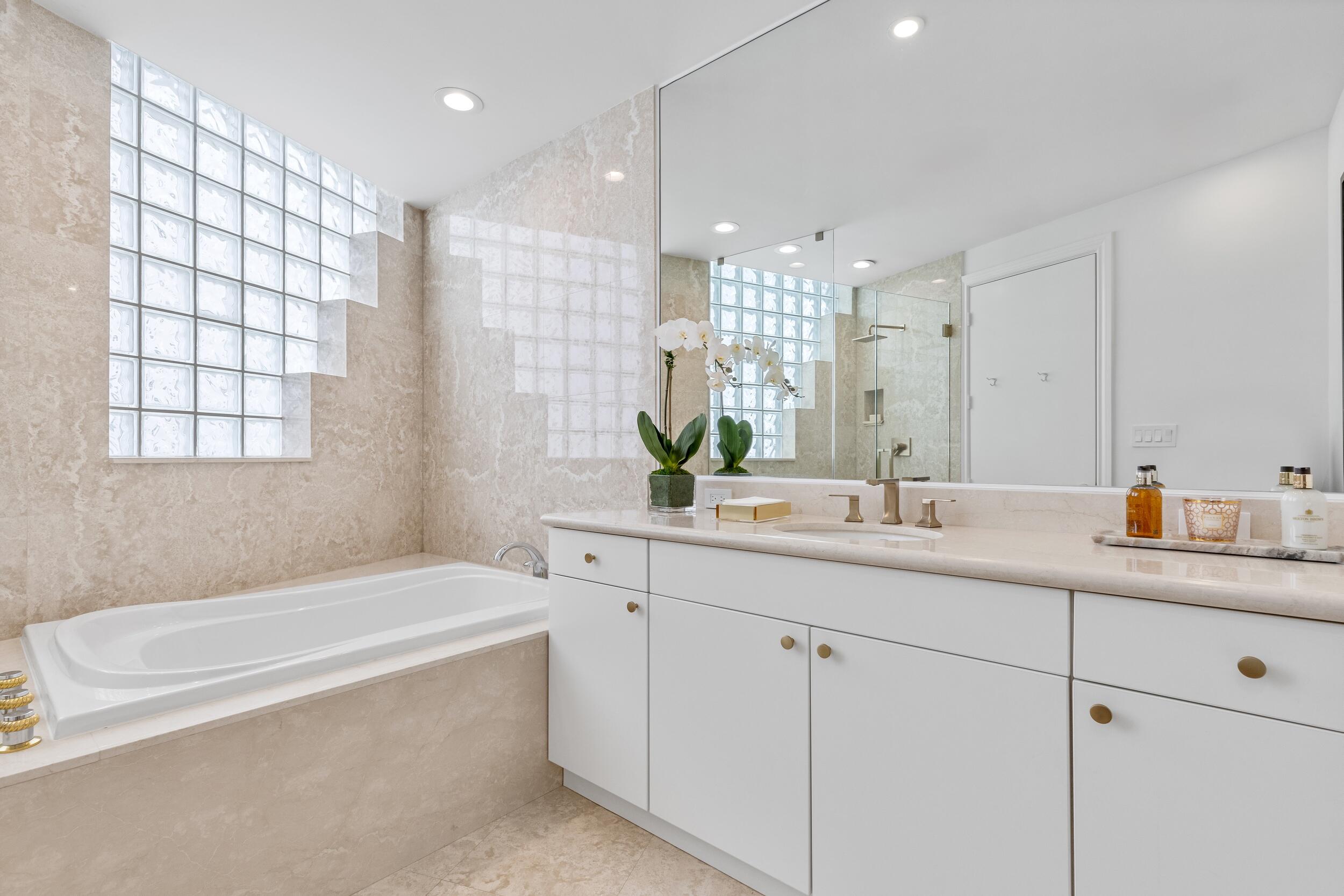 2494 South Ocean Boulevard, Unit C5 Boca Raton, FL 33432 - Photo 46 of 52 a bathroom with a tub a sink and mirror