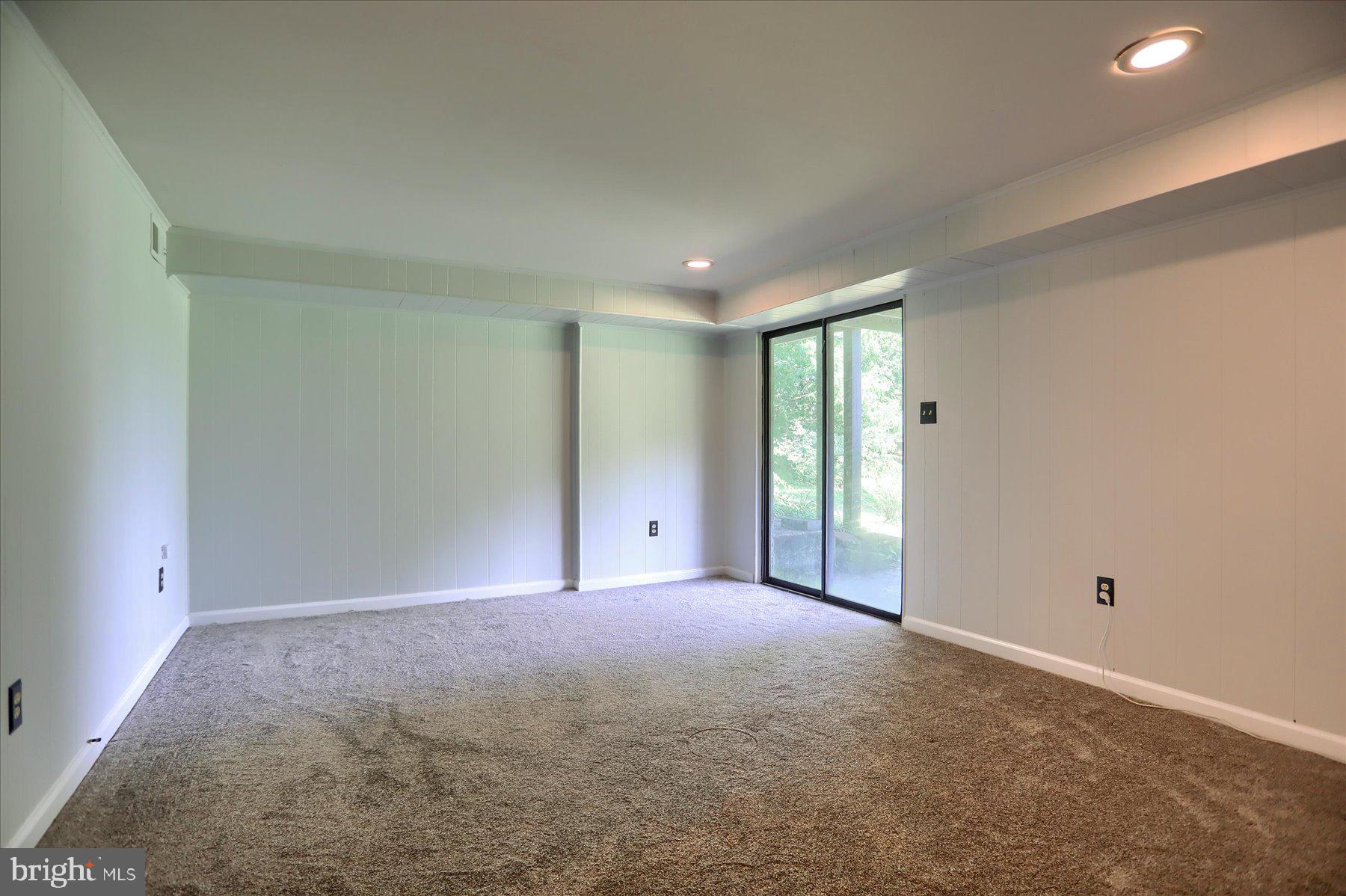 20 Stone Ridge Court, Unit 22 Baltimore, MD 21239 - Photo 16 of 37 Recreation Room in Basement w/ Walk Out Patio