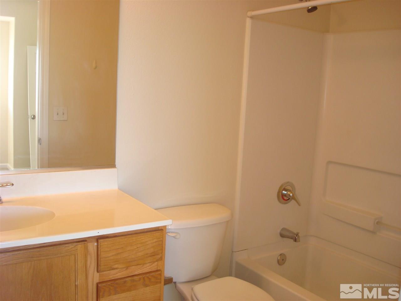 210 John Eugene Court Reno, NV 89503 - Photo 7 of 12 a bathroom with a granite countertop sink toilet and shower
