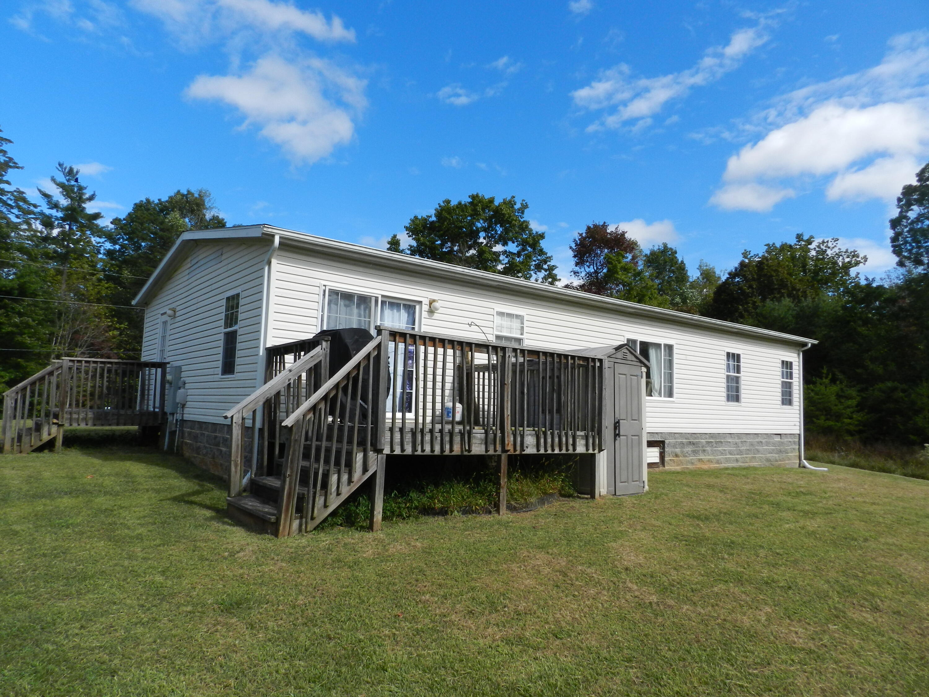 300 White Oak Road Boones Mill, VA 24065 - Photo 19 of 28 a view of a house with a yard and deck